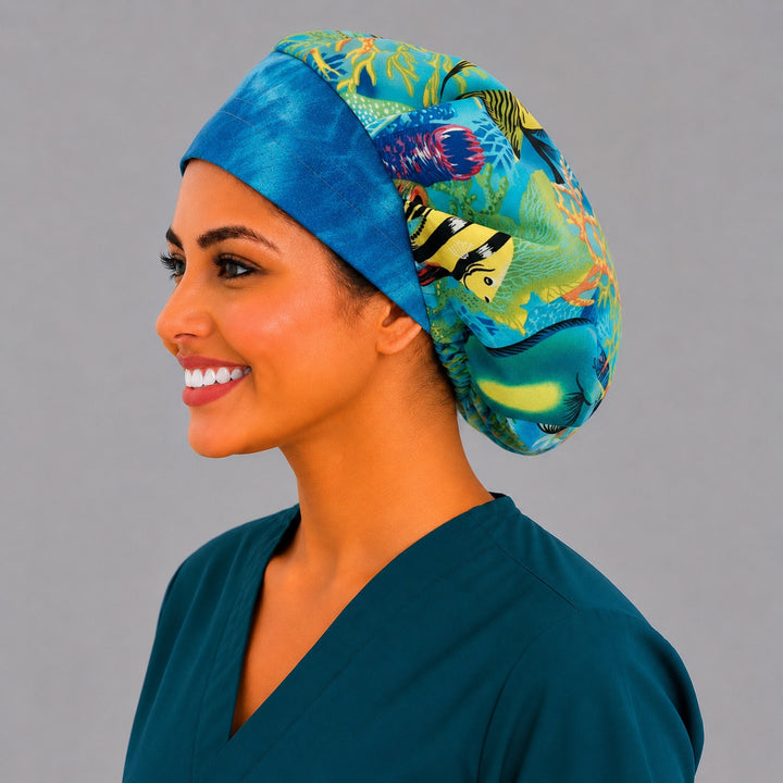 Ocean sea turtle bouffant scrub cap angled view on a smiling vet tech — coral reef fish print roomy cap that secures long thick hair