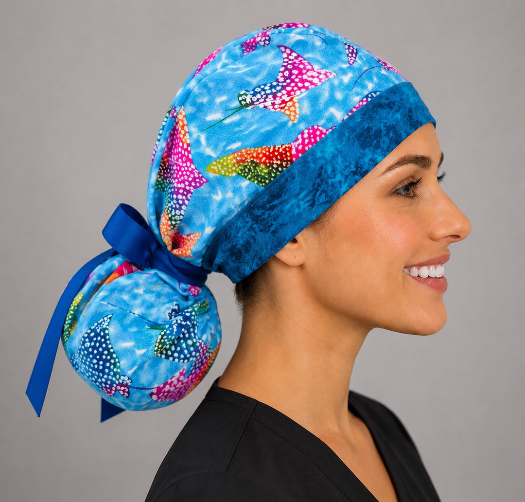 Ocean stingray ponytail surgical cap right side profile showing gathered ponytail pouch of rainbow manta rays and navy ribbon tie