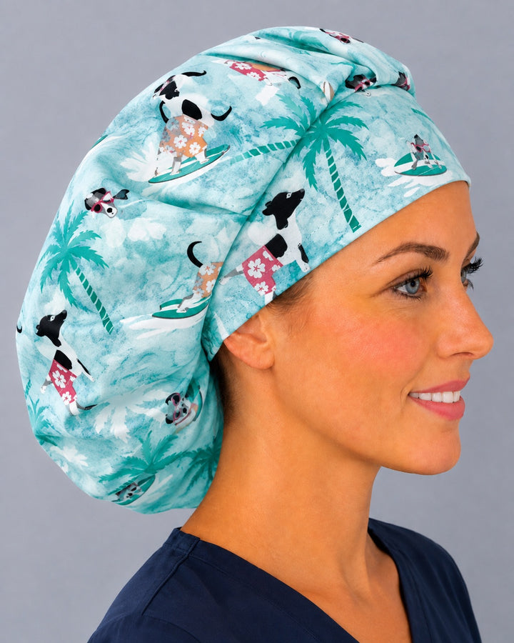 Ocean waves dog bouffant scrub cap, left side profile — white hibiscus and surfboard print, roomy elastic-back cap that secures long thick hair