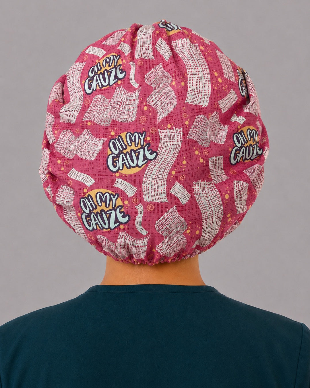 Back view of the Oh My Gauze bouffant scrub cap — full gathered pink coverage showing gauze squares and lettering across the crown