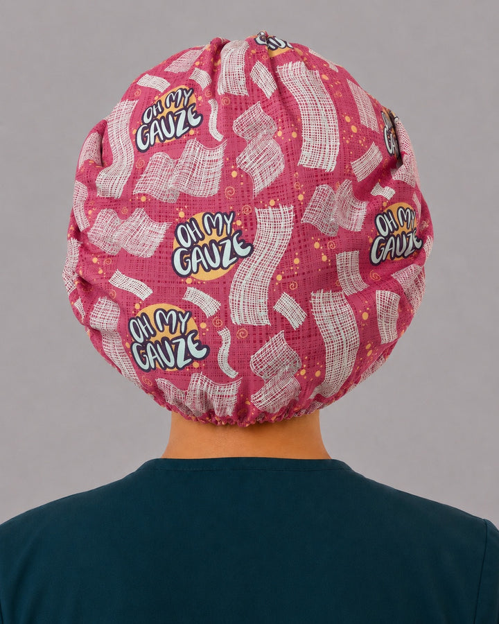 Back view of the Oh My Gauze bouffant scrub cap — full gathered pink coverage showing gauze squares and lettering across the crown