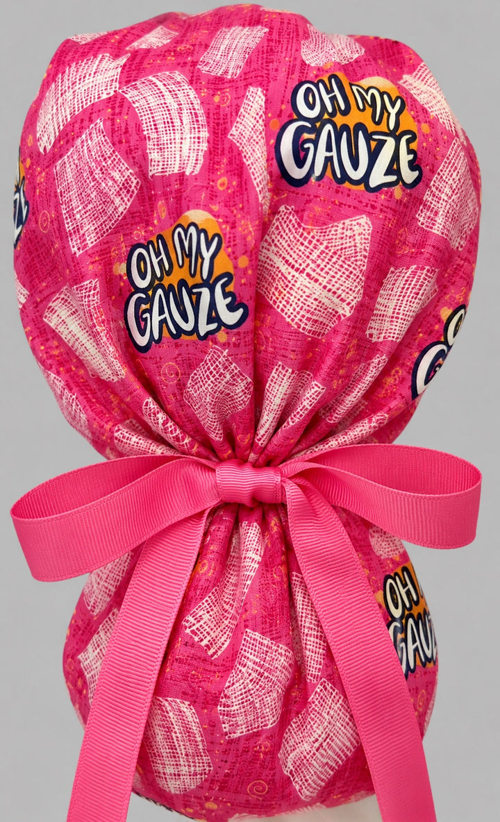 Oh My Gauze ponytail scrub cap back view close-up showing gathered pouch of pink gauze print, funny Oh My Gauze text and hot pink ribbon bow