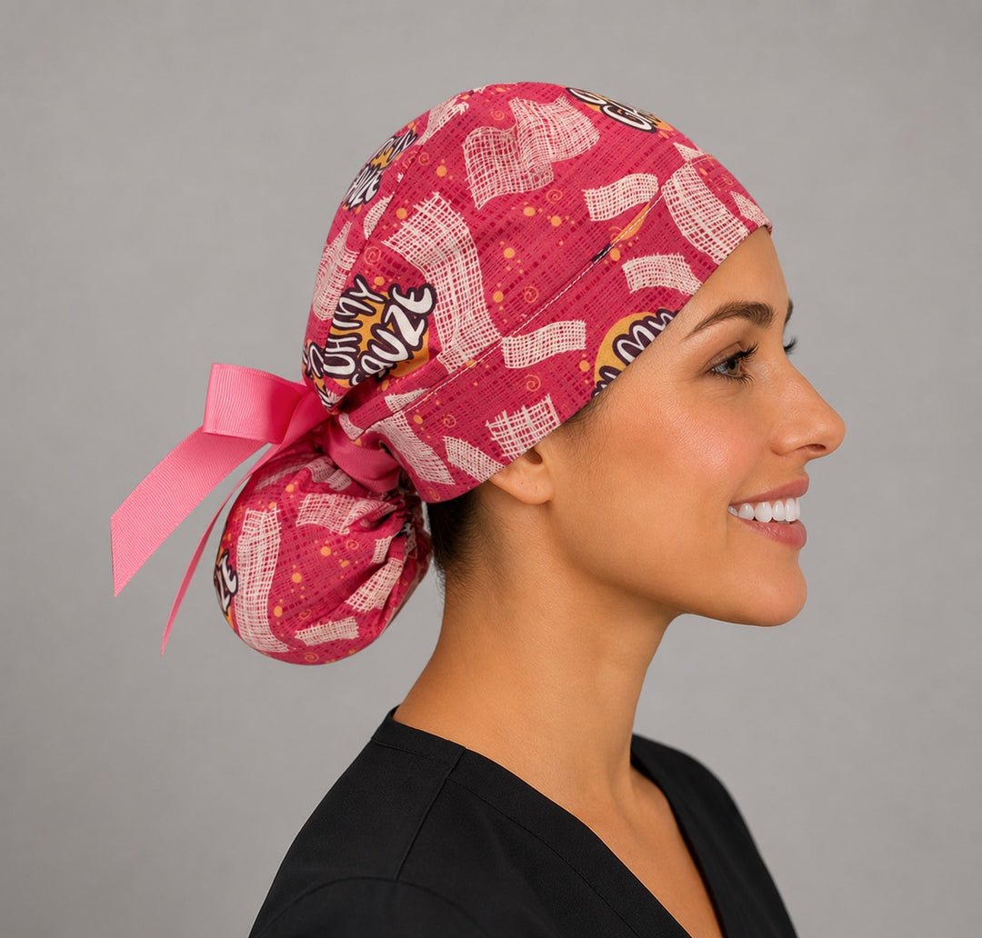 Oh My Gauze ponytail surgical cap left side profile showing gathered ponytail pouch of pink gauze print with hot pink ribbon tie
