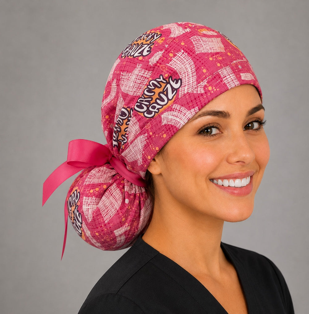 Oh My Gauze ponytail scrub cap left three-quarter angle showing full ponytail pouch of pink gauze print and hot pink ribbon bow