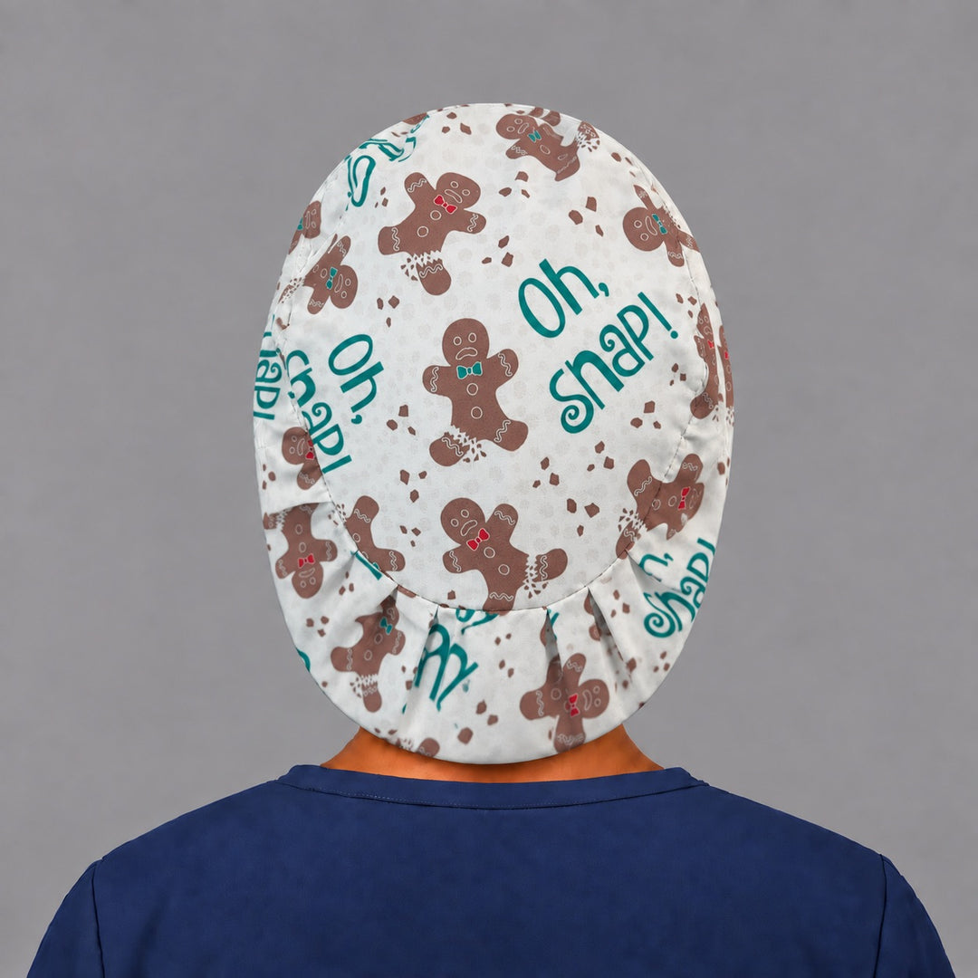Back view of the Oh Snap gingerbread Euro scrub cap — elastic gathered back showing gingerbread men and crumbs across the cream crown