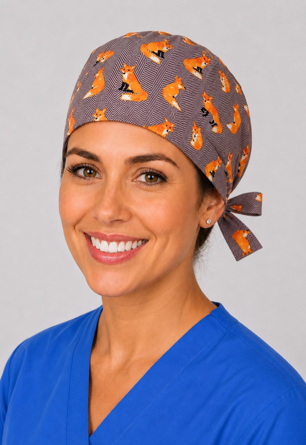 Three-quarter view of orange fox herringbone unisex adjustable surgical hat for vet techs and OR nurses