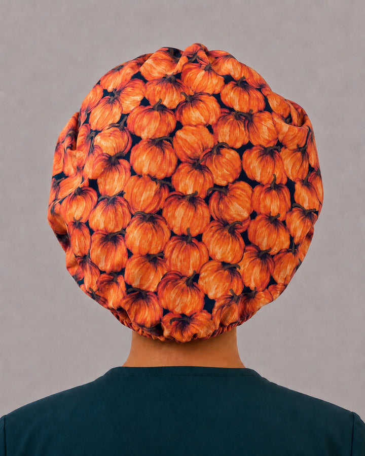 Orange pumpkin bouffant surgical cap, side view — Thanksgiving and fall print bouffant hat for OR nurses and vet techs