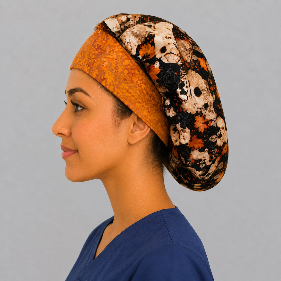 Orange and skull floral bouffant surgical cap, left side profile — gothic autumn print bouffant hat for surgical techs and vet techs