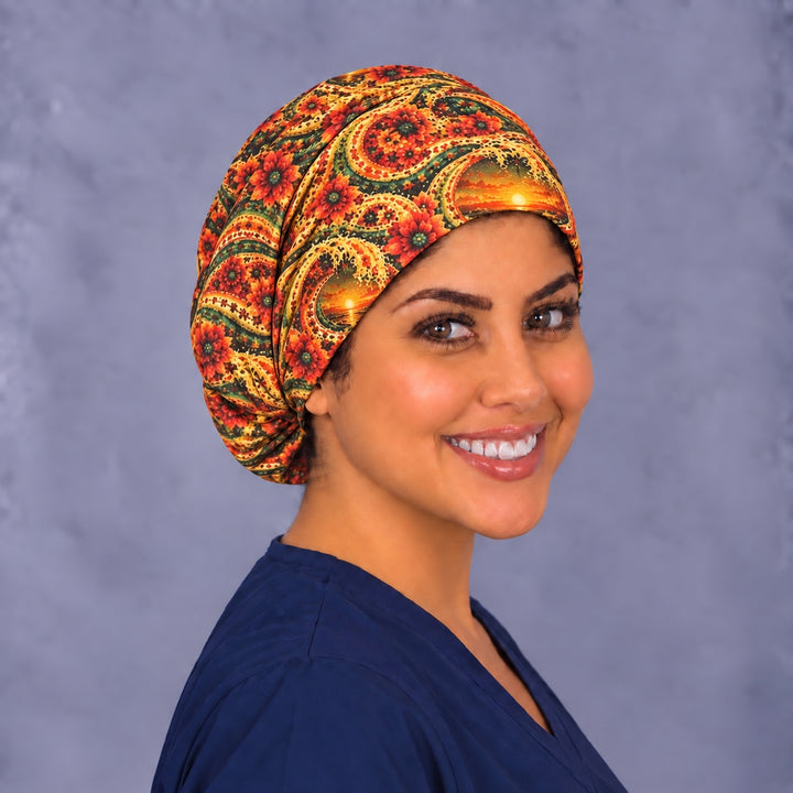 Orange sunset paisley Euro scrub cap, right angled smiling view — fiesta print for OR nurses and surgical techs