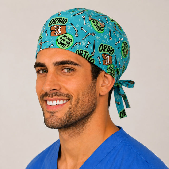 Opposite side profile of the orthopedic bone print scrub cap showing ORTHO badges and cartoon bones on teal