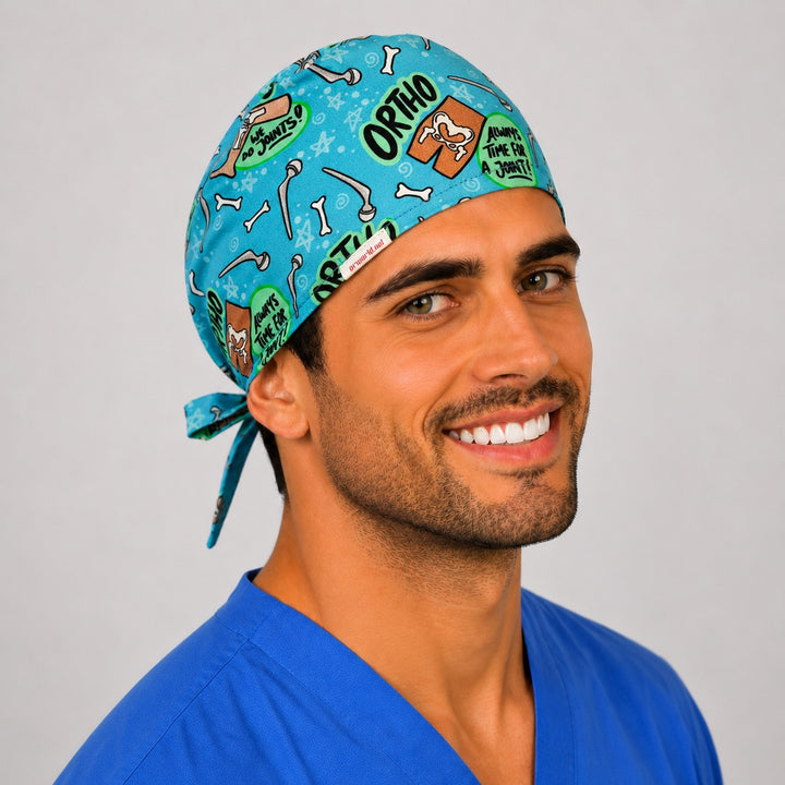 Funny ortho bone print scrub cap on a smiling male surgeon, side view showing the We Do Joints print and tie-back
