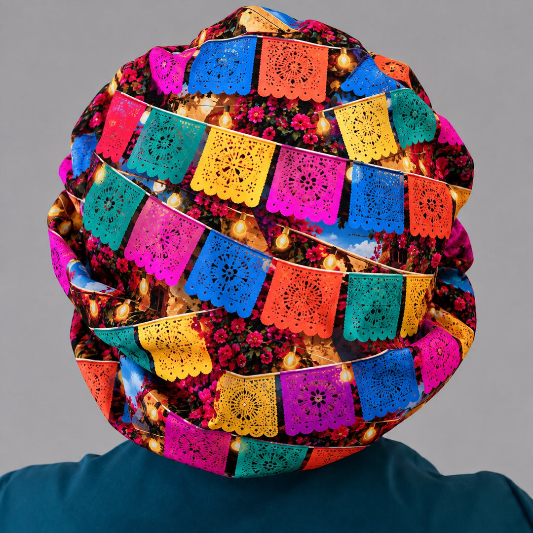 Back of a papel picado banner scrub cap showing the roomy bouffant crown for long hair
