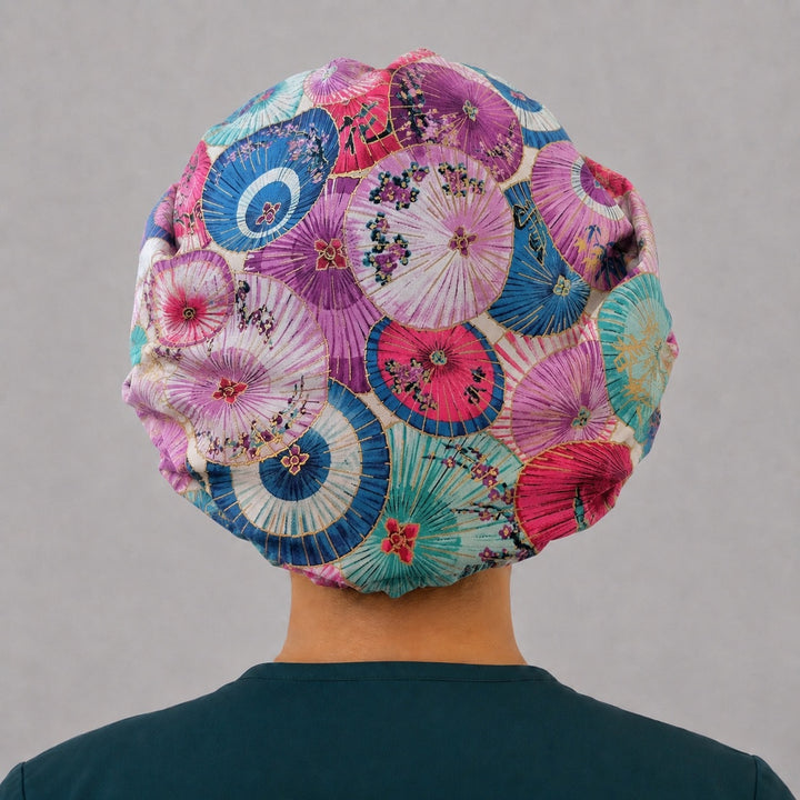Back view of the parasol bouffant scrub cap — full gathered coverage showing overlapping pink, purple and teal parasols