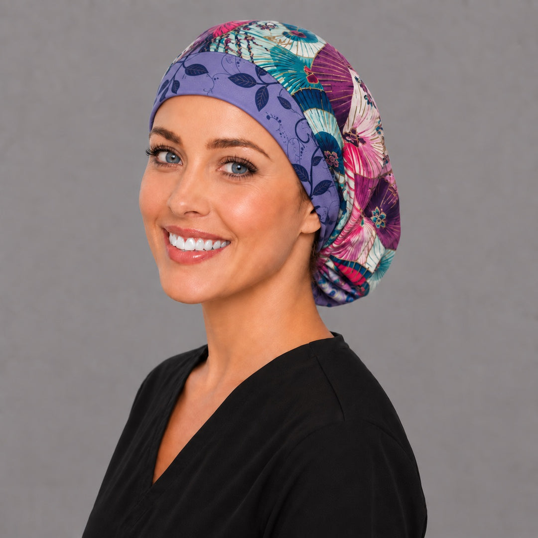 Woman wearing a parasol Euro scrub cap — fuchsia, teal and plum umbrellas with a lavender leaf band, adjustable purple surgical hat