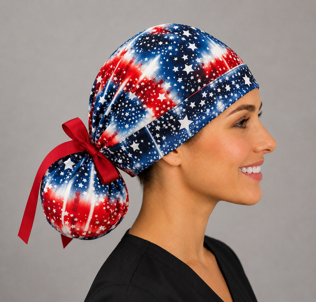 Patriotic flag ponytail surgical cap, side profile showing roomy ponytail bun and red ribbon ties, long hair scrub cap, OR World