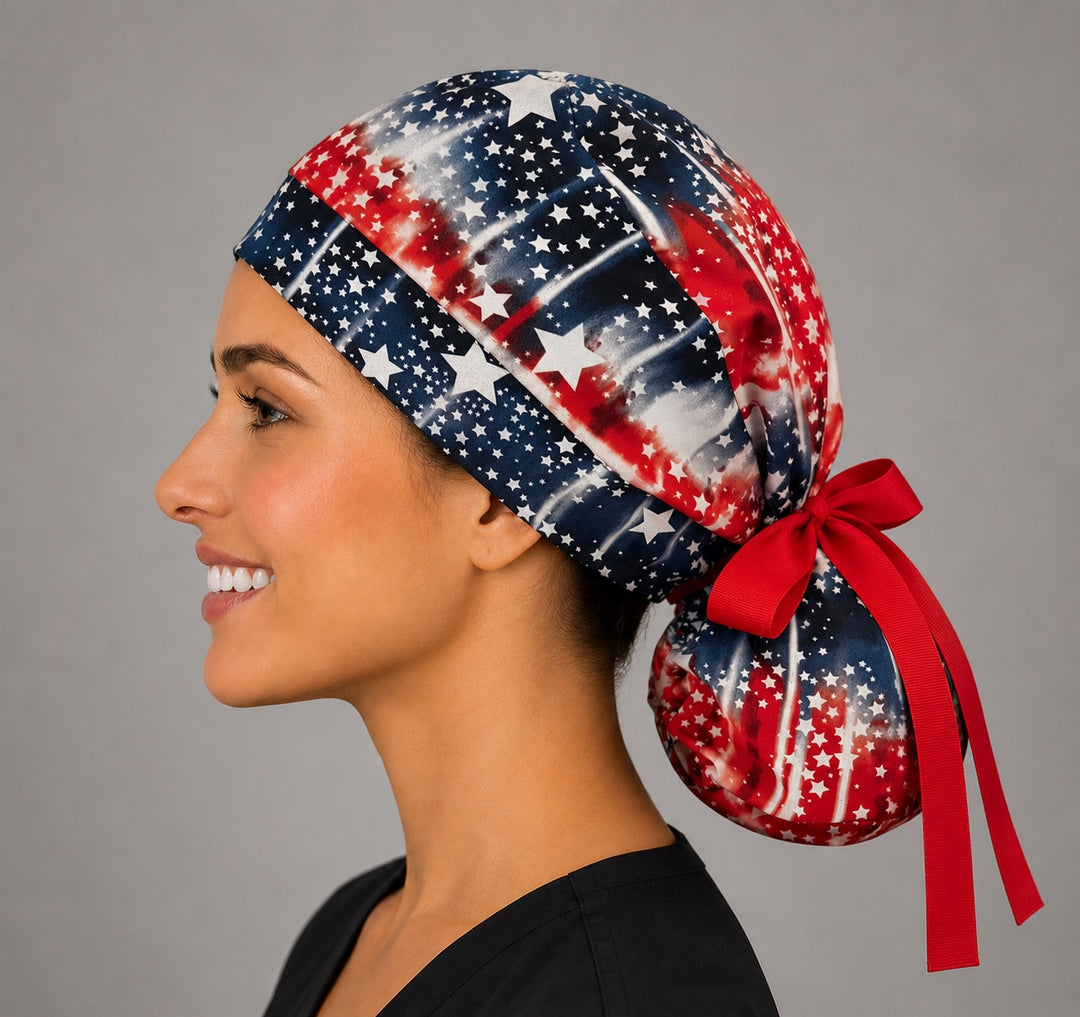 Patriotic American flag stars ponytail scrub cap, left side view with ponytail and red bow, USA surgical cap for long hair, OR World
