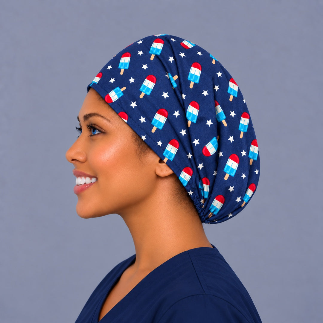 Woman wearing a Patriotic Popsicle Euro scrub cap, front view — red, white and blue popsicles on navy, adjustable Fourth of July surgical hat