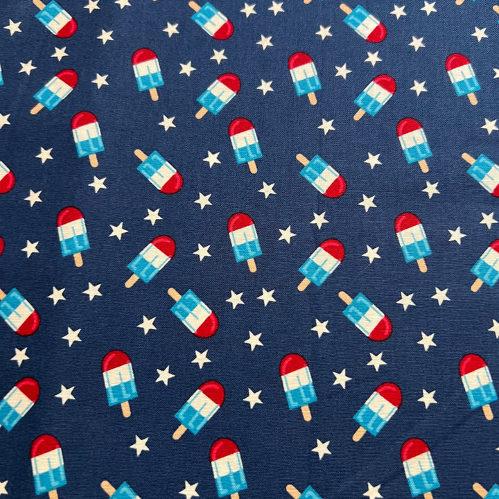 Patriotic popsicle fabric swatch, red white and blue rocket popsicles with white stars on navy cotton scrub cap print detail