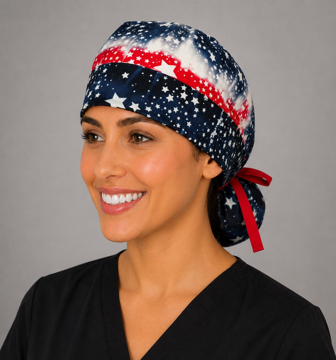 Woman wearing patriotic tie-dye ponytail scrub cap with American flag stars, front view, red white and blue nurse surgical hat, OR World
