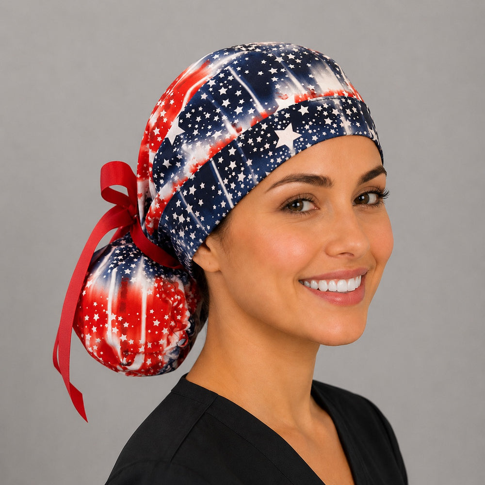Red white and blue tie-dye ponytail scrub cap for women, angled view with ponytail bun, patriotic OR nurse hat, OR World