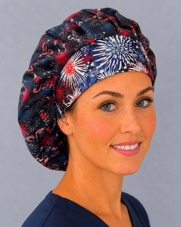 Patriotic USA bouffant surgical cap for long hair, left side profile — navy fireworks print with deep gathered fit for OR nurses