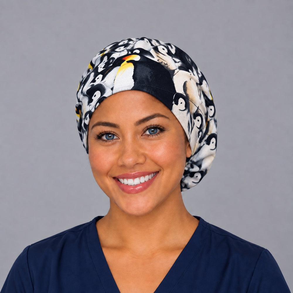 Woman wearing a penguin Euro scrub cap, front view — emperor penguin chicks print, adjustable surgical hat for nurses