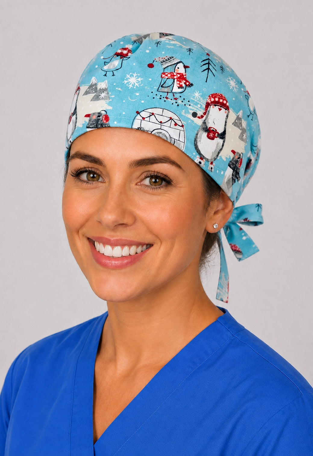 Three-quarter view of penguin and igloo unisex winter adjustable surgical hat for nurses and surgical techs