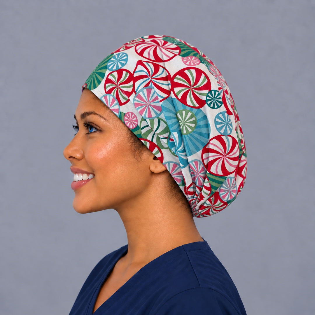 Left side profile of the peppermint candy Euro surgical hat — spinning swirl print, breathable cotton cap for nurses