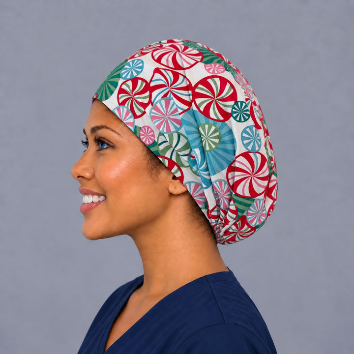Left side profile of the peppermint candy Euro surgical hat — spinning swirl print, breathable cotton cap for nurses