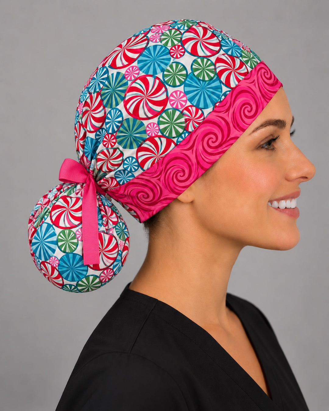 Right side profile of the peppermint swirl ponytail scrub cap — gathered pony pouch tied with a hot pink grosgrain bow
