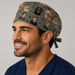 Smiling male surgeon wearing a personalized photo scrub cap on a forest-green background with kids' and dogs' photos and pine trees, front view — custom photo surgical hat for men, handmade in the USA by OR World.