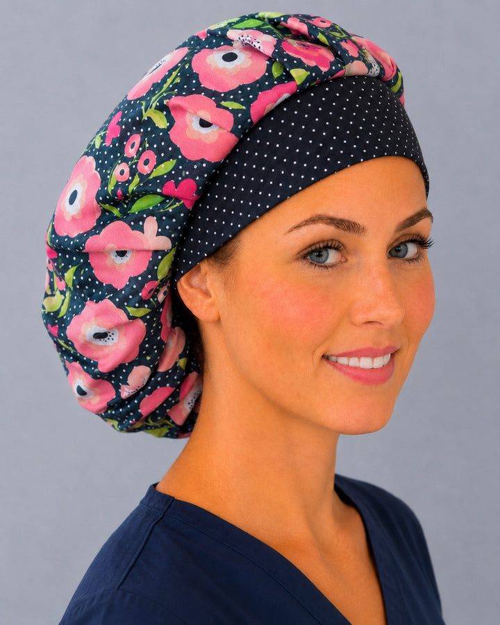 Top-down view of the Petals and Polka Dots bouffant scrub cap — full roomy crown showing pink poppies and white dots on navy black