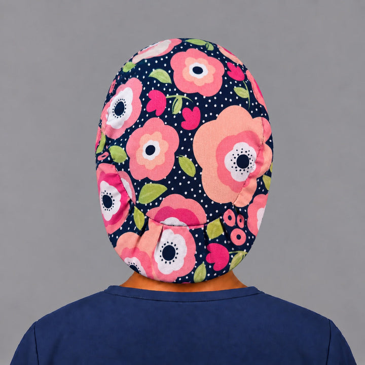 Back view of the petals and polka dots Euro scrub cap — elastic gathered back showing poppies across the black crown
