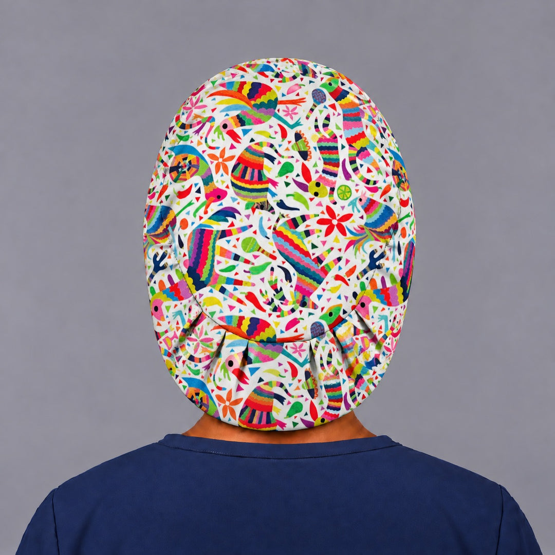Back view of the piñata print euro cap, showing the oval crown panel and the evenly pleated elastic hem gathered at the base of the neck