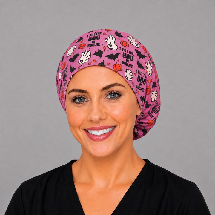 Pink ghost and pumpkin Euro surgical hat, right angled smiling view — handmade Halloween cap, USA made