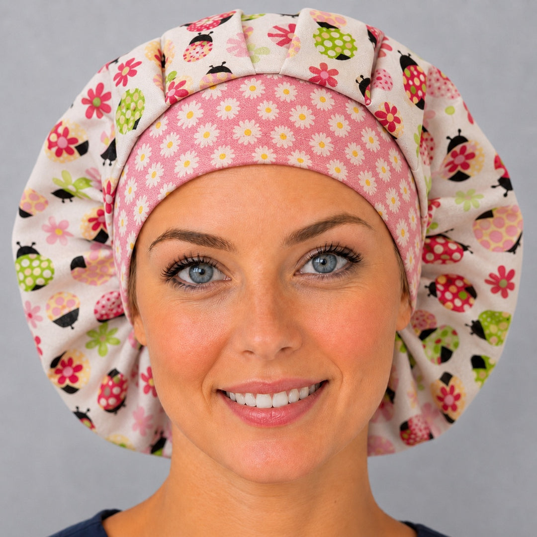 Side view of the pink ladybug bouffant surgical hat — cream ladybug and flower print with white daisy band, roomy cotton cap for nurses
