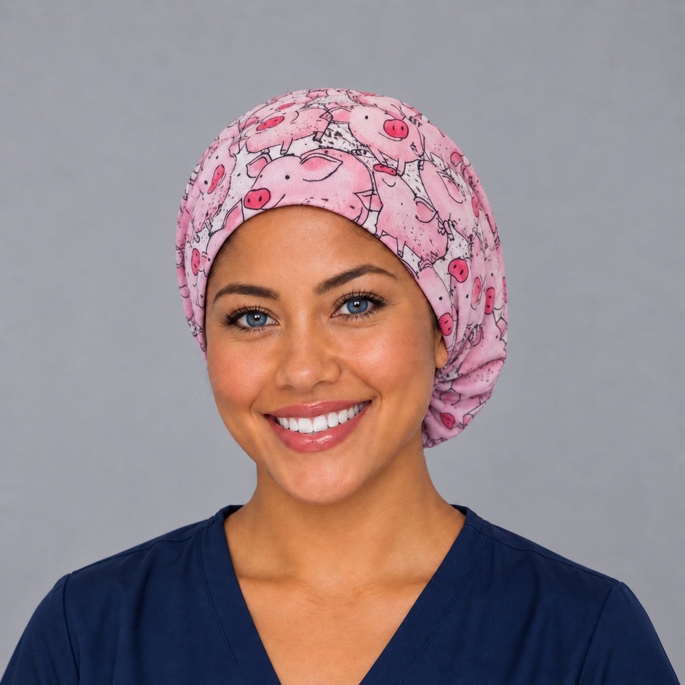 Woman wearing a pink pig Euro scrub cap, front view — cheerful farm pigs print, adjustable surgical hat for nurses