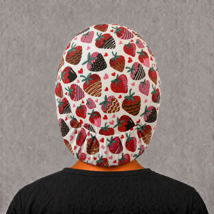 Pink strawberry Euro cap for women, left angled view — sweet dessert print for OR nurses and surgical techs