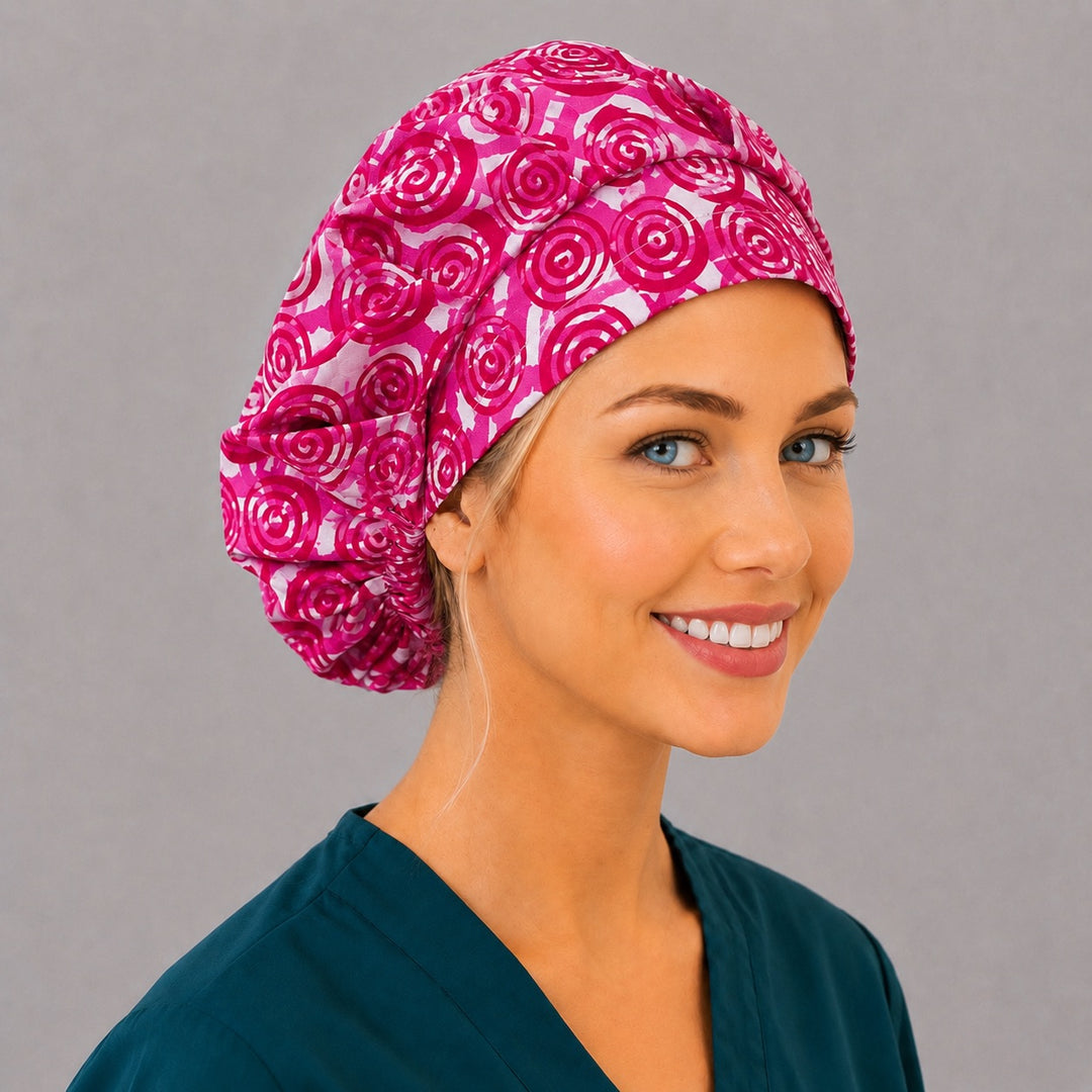 Back view of the pink swirl bouffant scrub cap — full gathered fit showing magenta spirals and rosettes across the crown