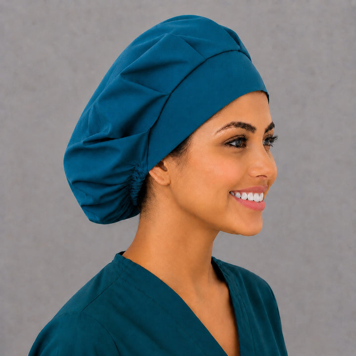 Right side profile of the plain blue bouffant surgical hat — roomy elastic gathered back, breathable cotton cap for OR staff
