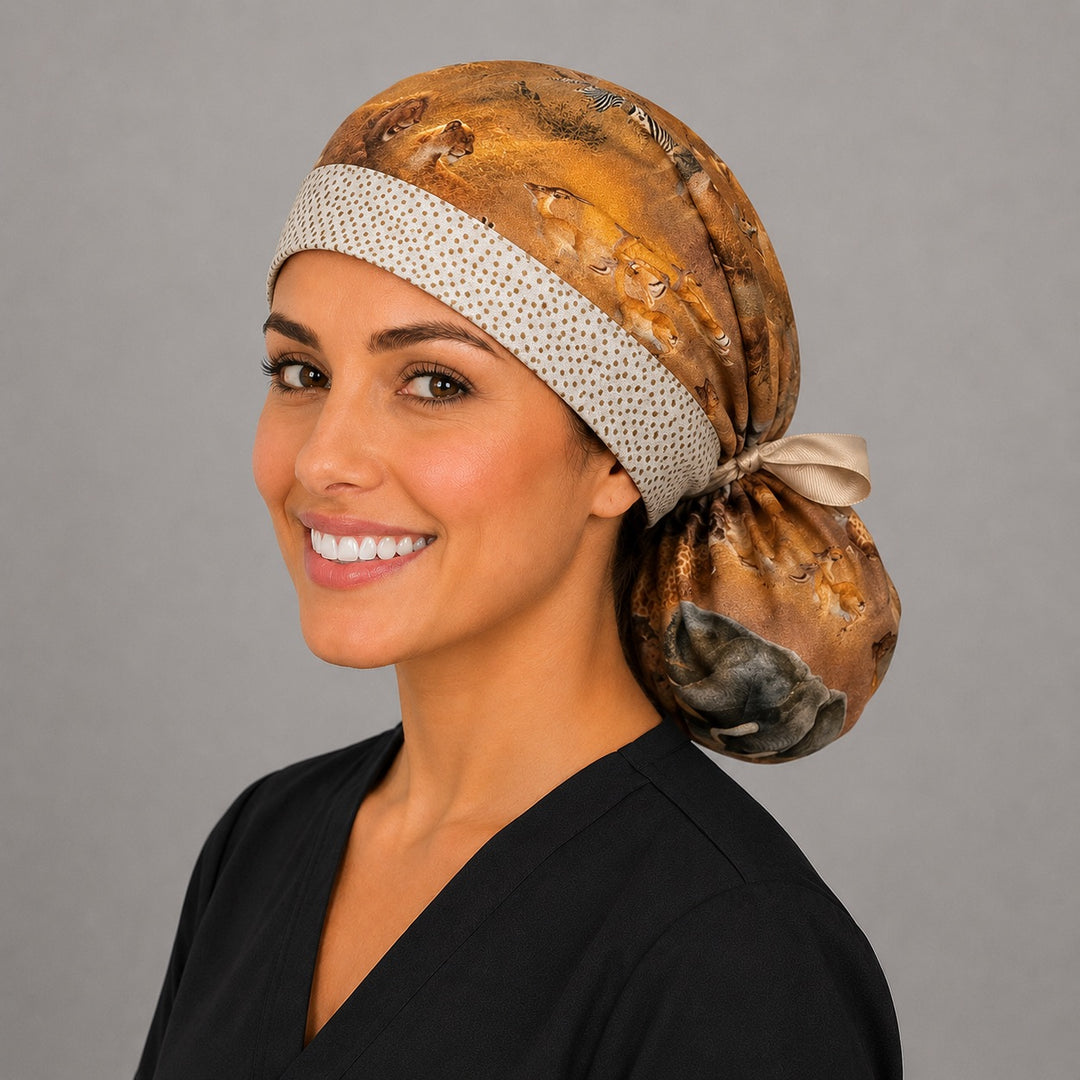 Side profile of African safari animal print ponytail scrub cap holding long hair with elephant and lion wildlife print