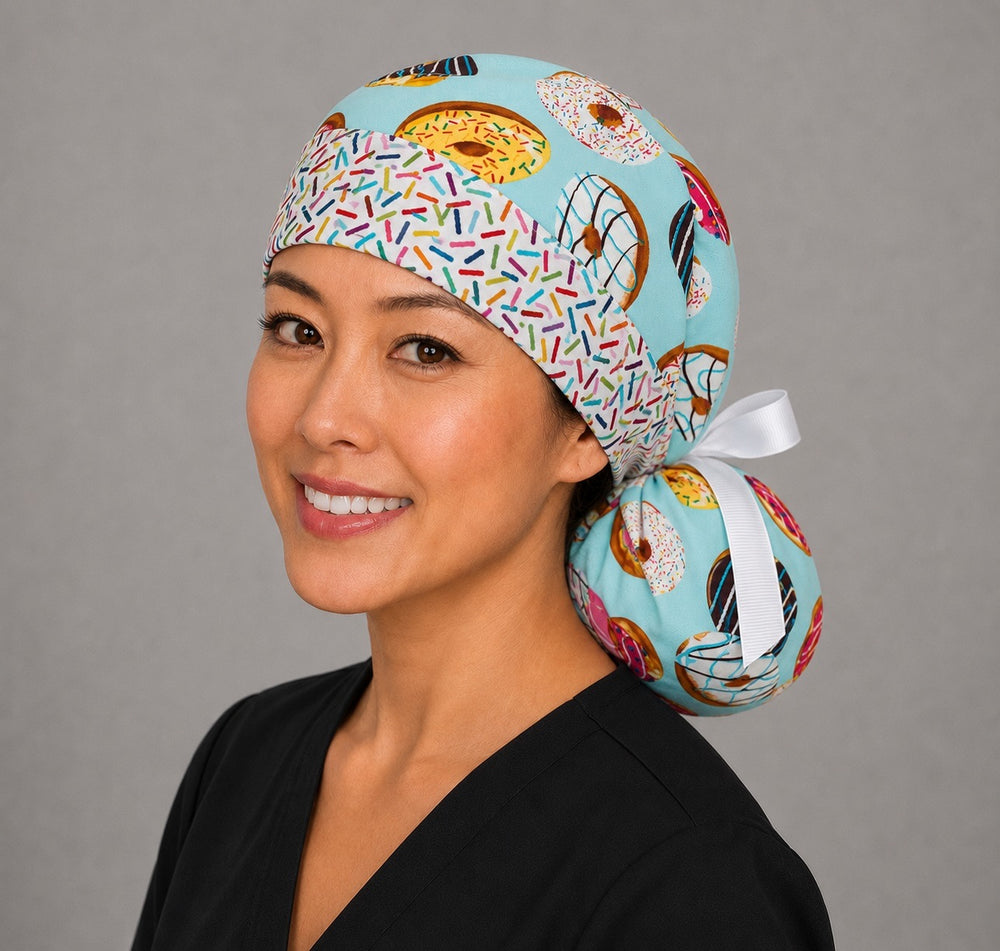 Right profile of donut print ponytail scrub cap for women showing sprinkle headband and ponytail pouch with white bow