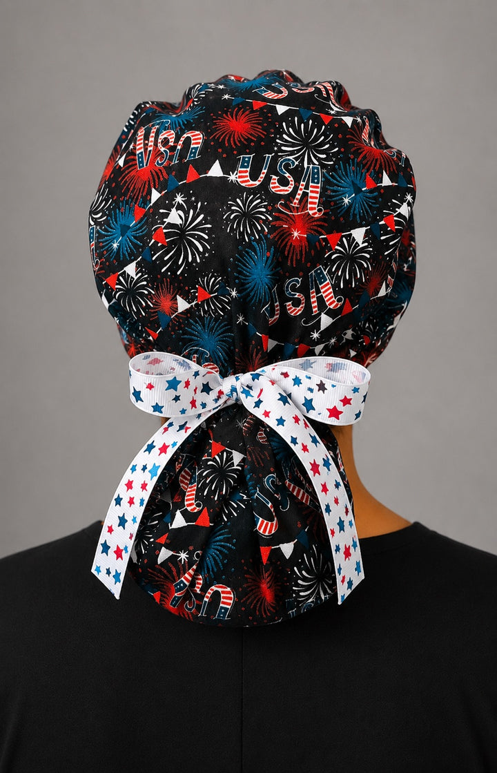 Back view of USA fireworks ponytail scrub cap ponytail pouch with white star-print grosgrain bow tie