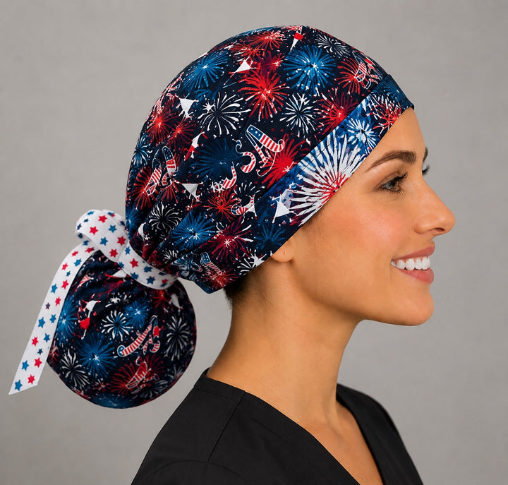 Side view of Red White &amp; Boom patriotic fireworks ponytail scrub cap for women with USA print and star ribbon tie
