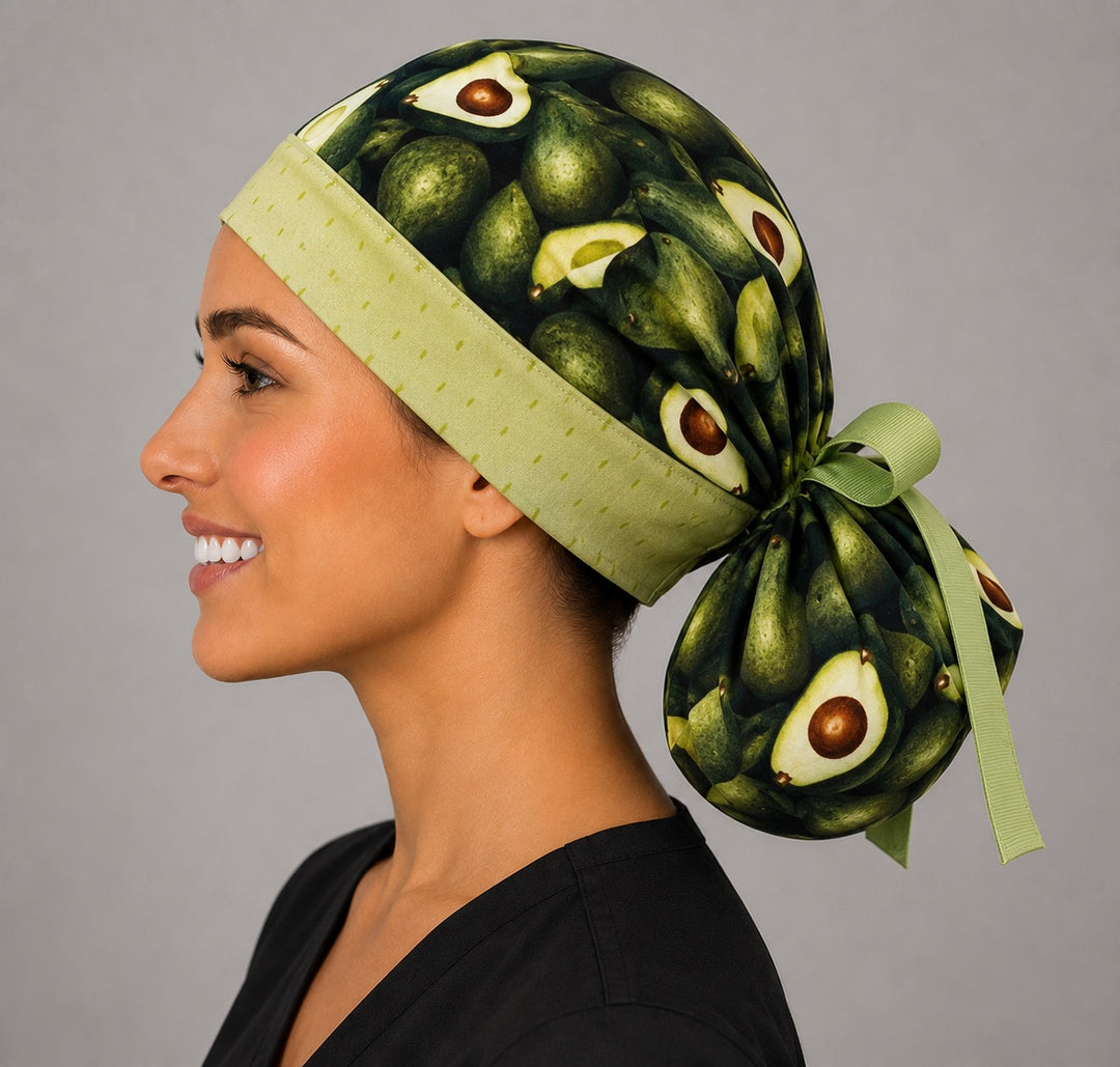 Avocado print ponytail scrub cap left side profile with roomy ponytail pouch full of avocados and lime green bow