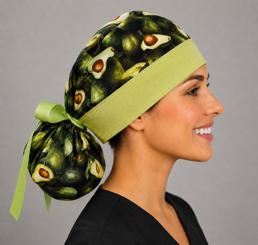 Avocado print ponytail surgical cap right side profile showing green band, gathered pouch and lime grosgrain ribbon tie