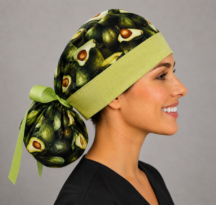 Avocado print ponytail surgical cap right side profile showing green band, gathered pouch and lime grosgrain ribbon tie