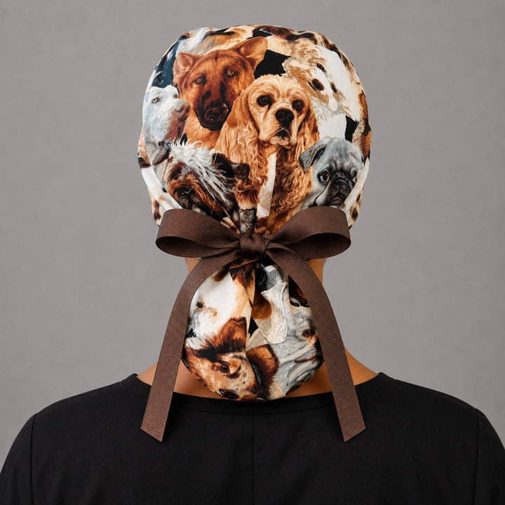 Dog lover ponytail scrub cap back view on mannequin showing double gathered pouch of dog faces and brown ribbon bow