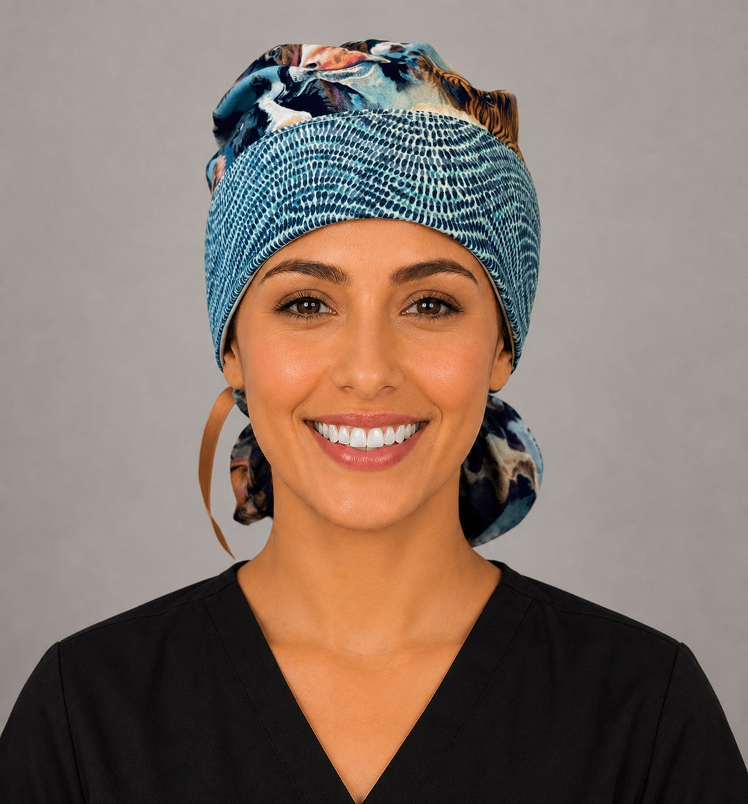 Ponytail scrub cap for women in Highland cow print, front view with blue tie-dye headband and adjustable ribbon