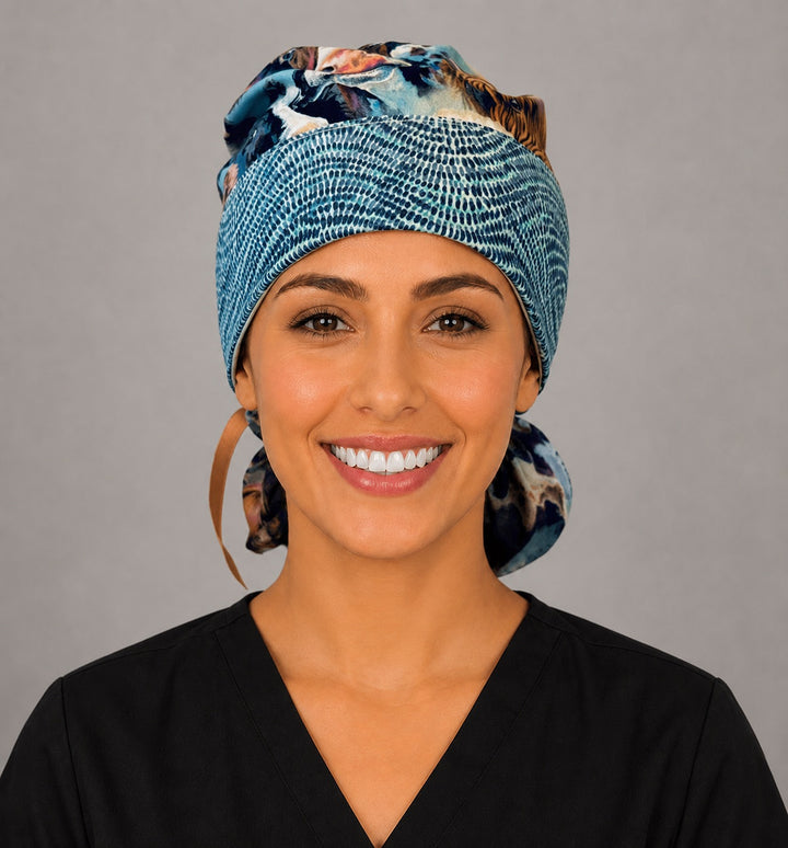Ponytail scrub cap for women in Highland cow print, front view with blue tie-dye headband and adjustable ribbon